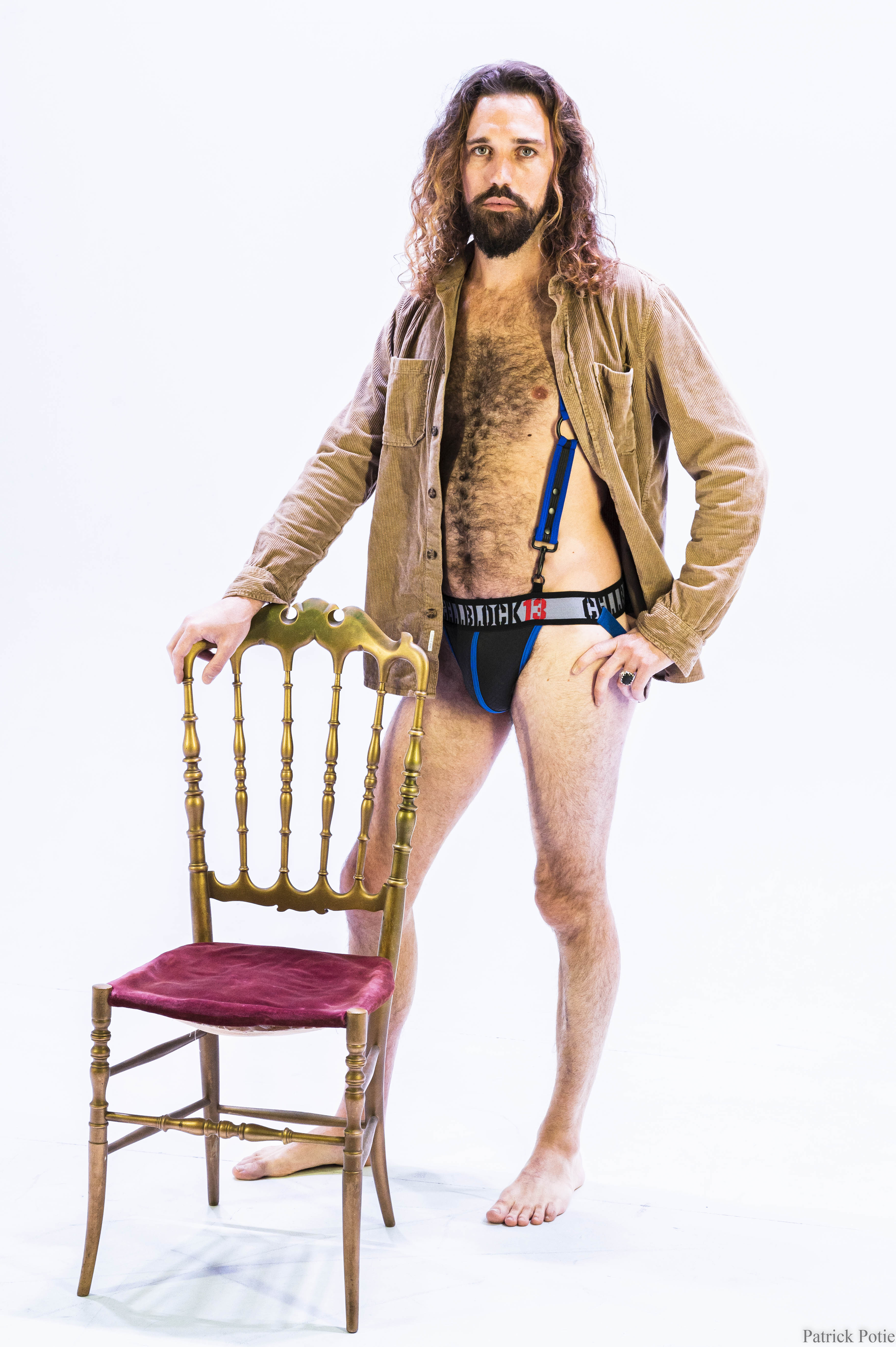 portrait d'un homme poilu et barbu, avec une chemise en velours et un harnais en néoprène